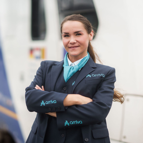 Machinist van Arriva staat lachend met de armen over elkaar voor haar trein. Machinist van Arriva staat lachend met de armen over elkaar voor haar trein.
